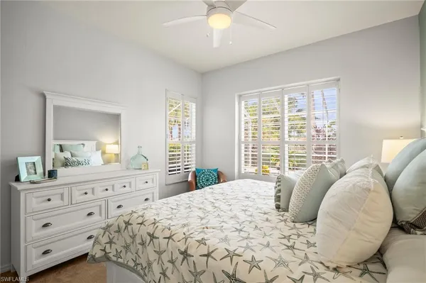 a bedroom with a large bed and a dresser