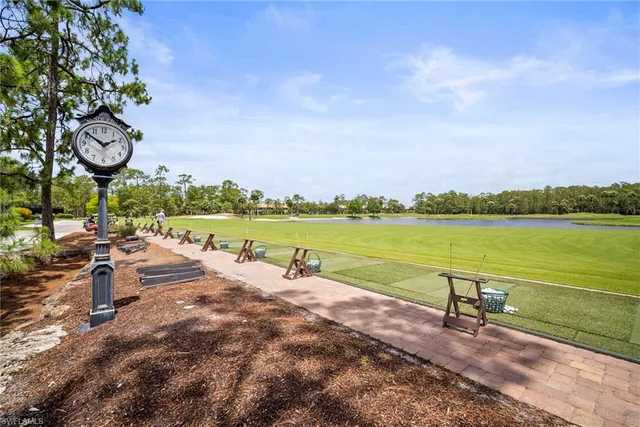 a view of a lake with a table and chairs next to a lake