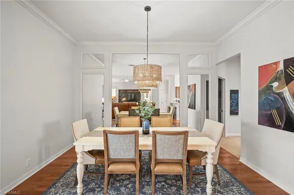 a dining room with furniture a chandelier and window