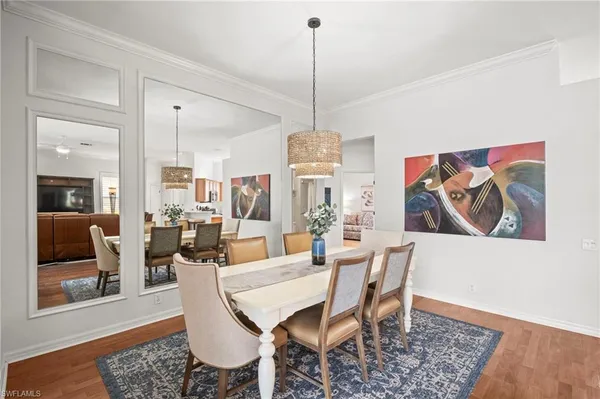 a dining room with furniture and wooden floor