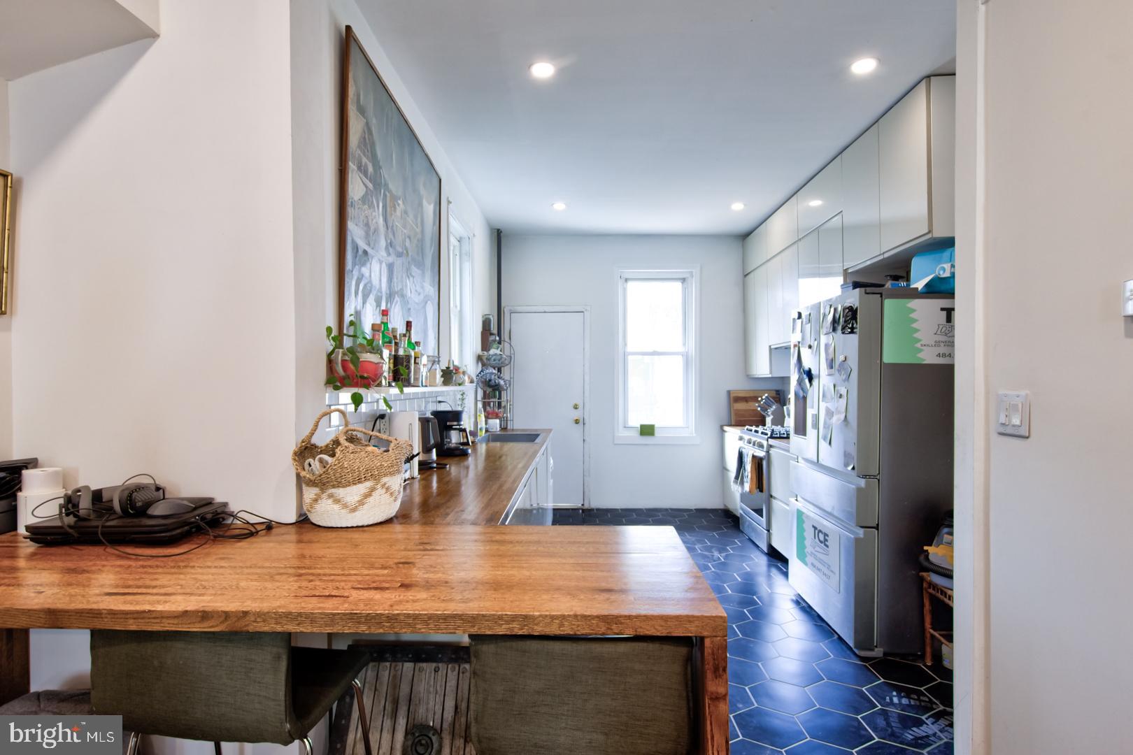 2044 Tasker Street Philadelphia, PA 19145 - Photo 4 of 15 a view of a dining room with furniture a rug and wooden floor