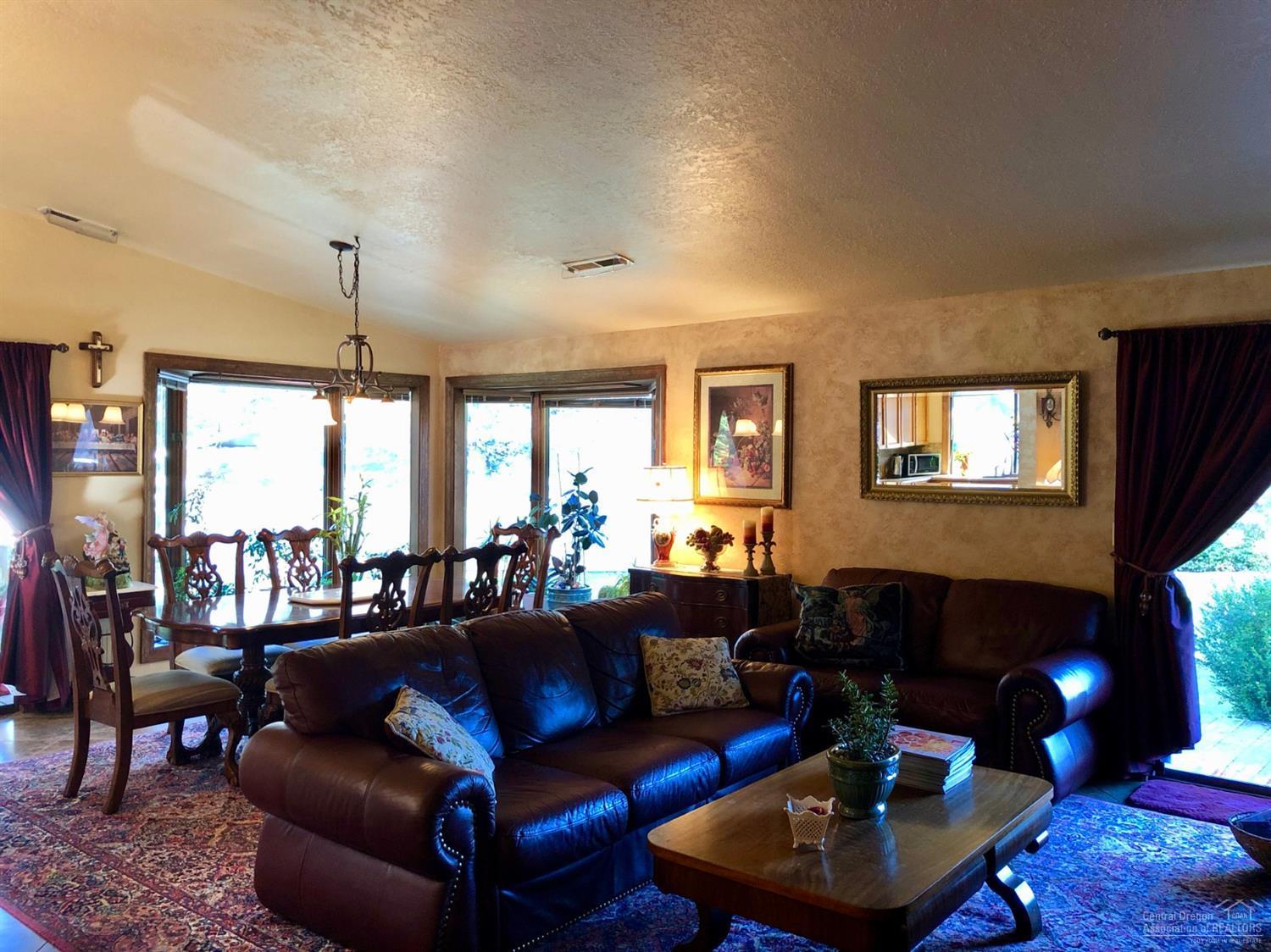 20416 Bullblock Road Bend, OR 97702 - Photo 9 of 23 a living room with furniture and a fireplace