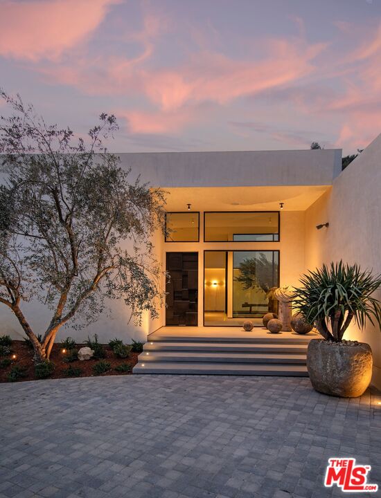 1731 Rising Glen Road Los Angeles, CA 90069 - Photo 2 of 27 a front view of a house with a yard