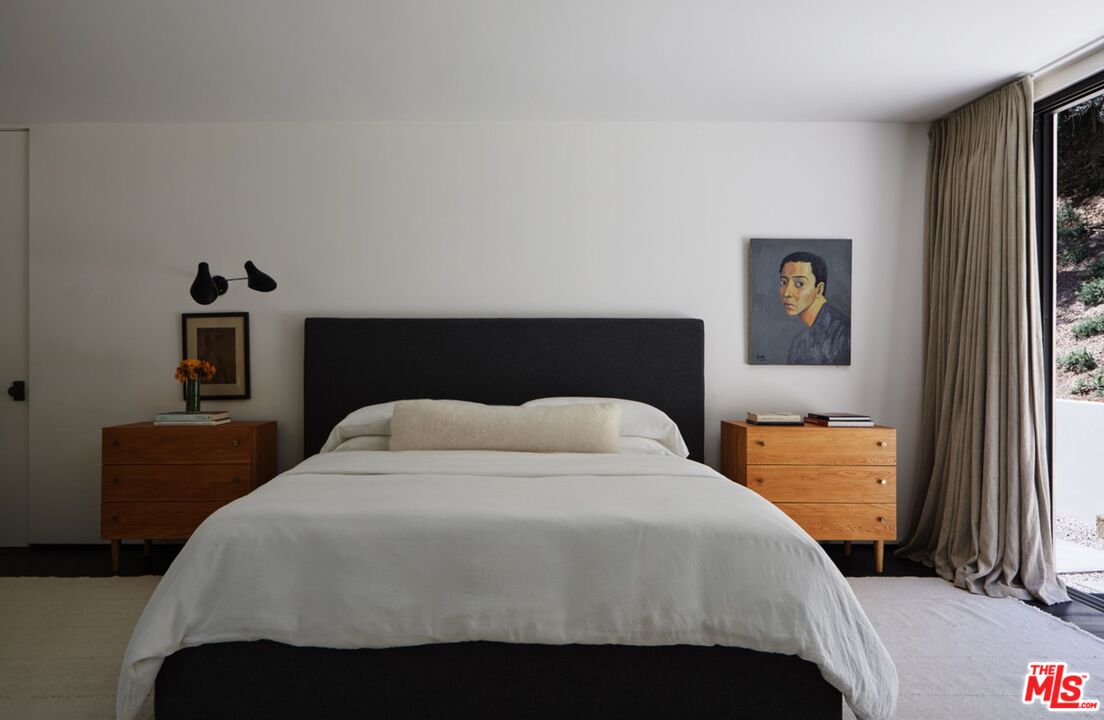 1731 Rising Glen Road Los Angeles, CA 90069 - Photo 12 of 27 a bedroom with a bed and wooden floor