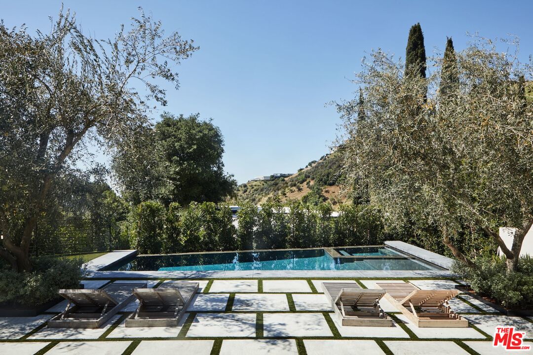 1731 Rising Glen Road Los Angeles, CA 90069 - Photo 20 of 27 a view of a swimming pool with a yard and sitting area