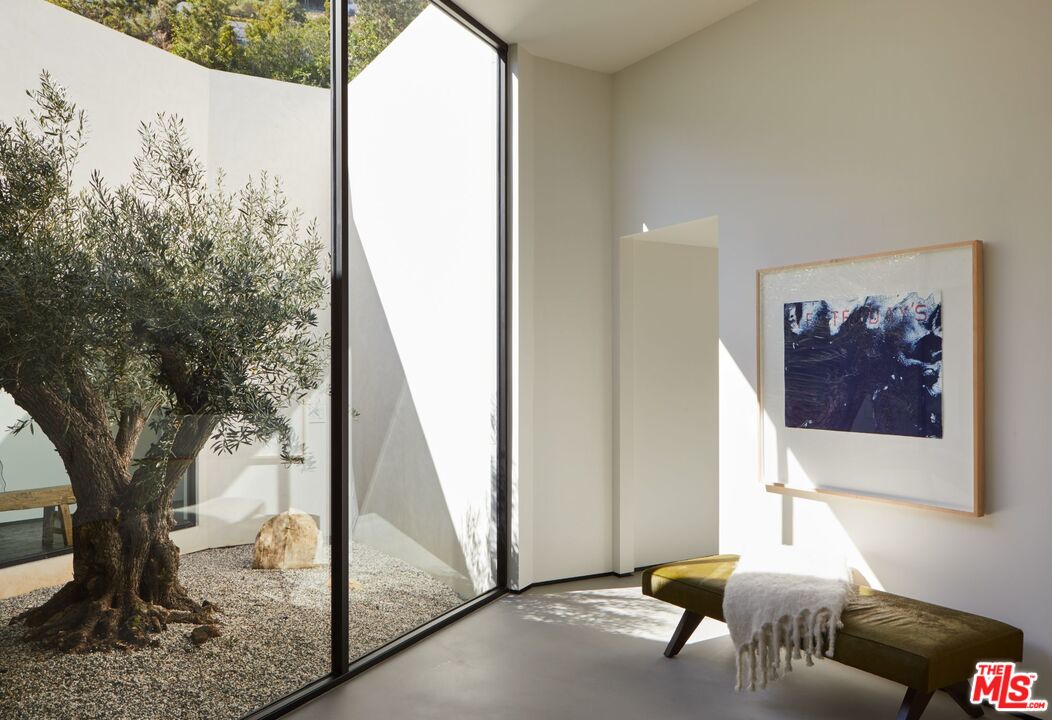 1731 Rising Glen Road Los Angeles, CA 90069 - Photo 3 of 27 a living room with furniture and a floor to ceiling window