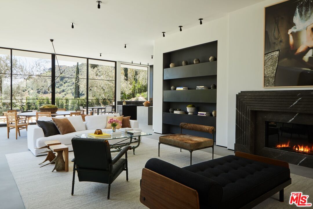 1731 Rising Glen Road Los Angeles, CA 90069 - Photo 5 of 27 a living room with furniture fireplace and a floor to ceiling window