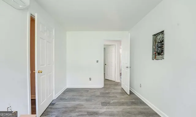 a kitchen with a sink a refrigerator and white cabinets