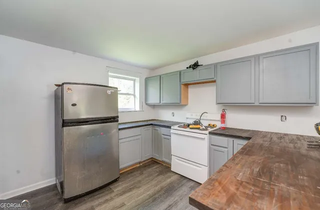 a view of kitchen and hall with wooden floor