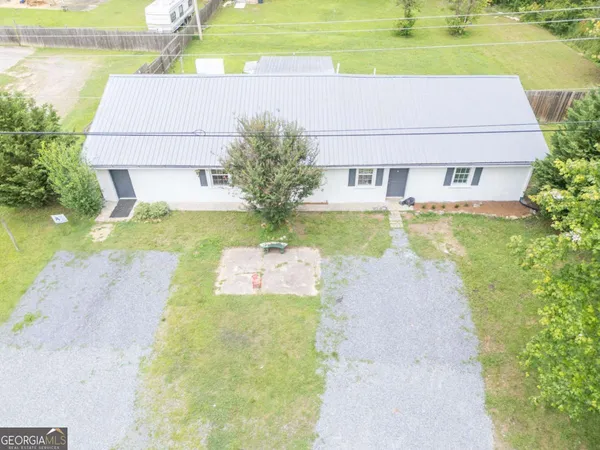 an aerial view of a house with a yard