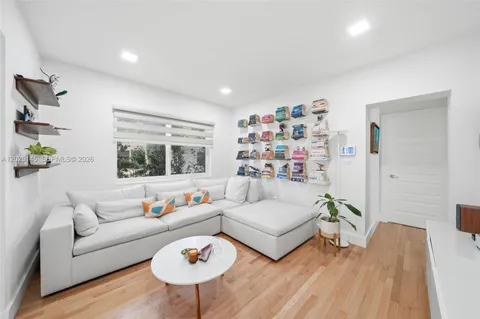 a living room with furniture and a wooden floor