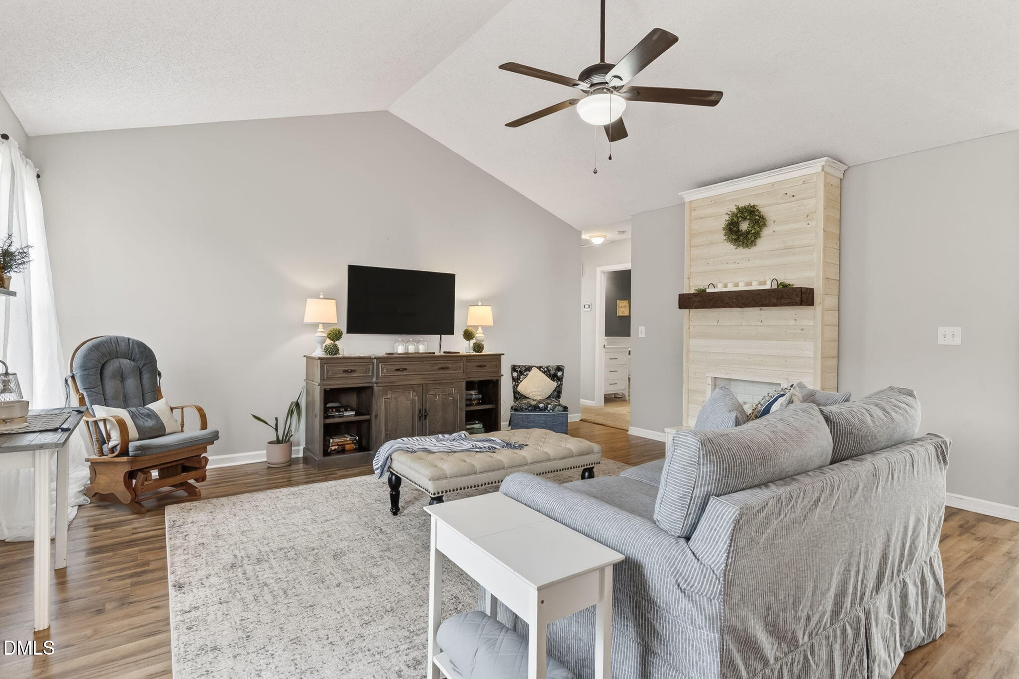1101 Live Oak Road Coats, NC 27521 - Photo 5 of 29 a living room with furniture a fireplace and a flat screen tv