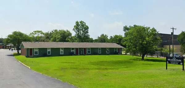 a view of a house with a yard and sitting area