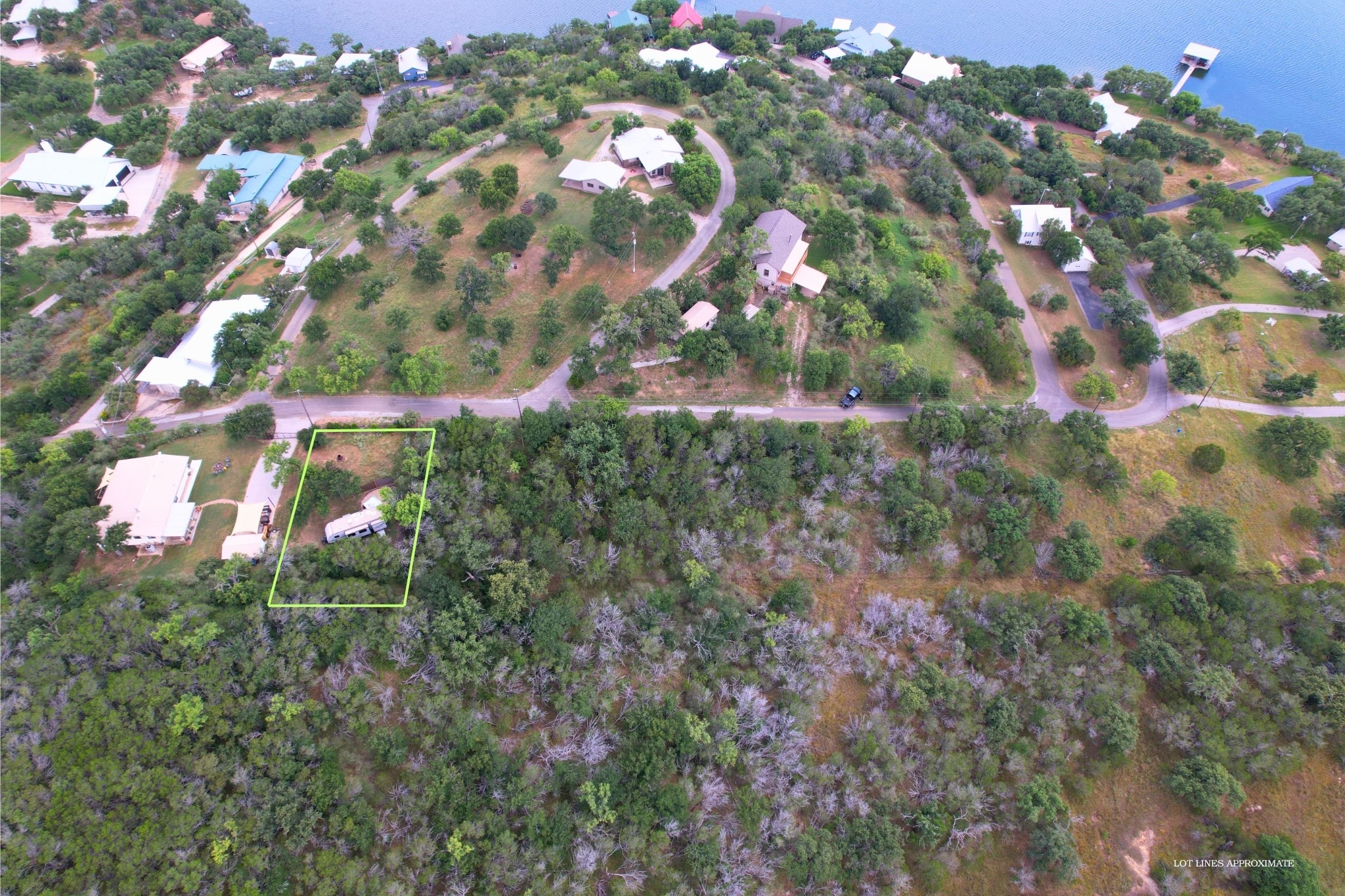 706 Cr138a Road Burnet, TX 78611 - Photo 4 of 18 A spacious lot featuring mature trees and a tranquil water view, ready for your dream home.