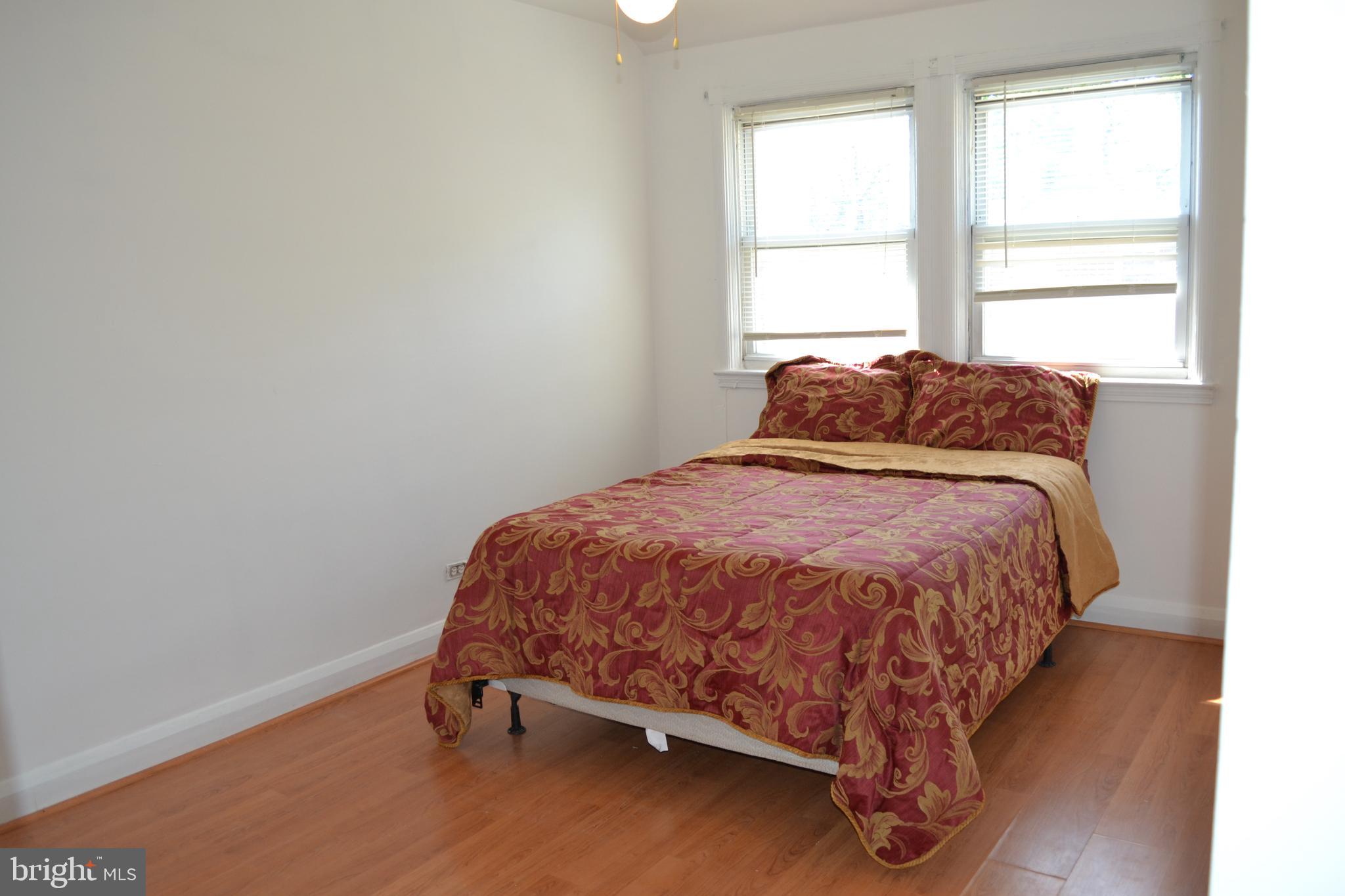 5153 Frederick Avenue Baltimore, MD 21229 - Photo 16 of 29 a bed sitting in a bedroom next to a window