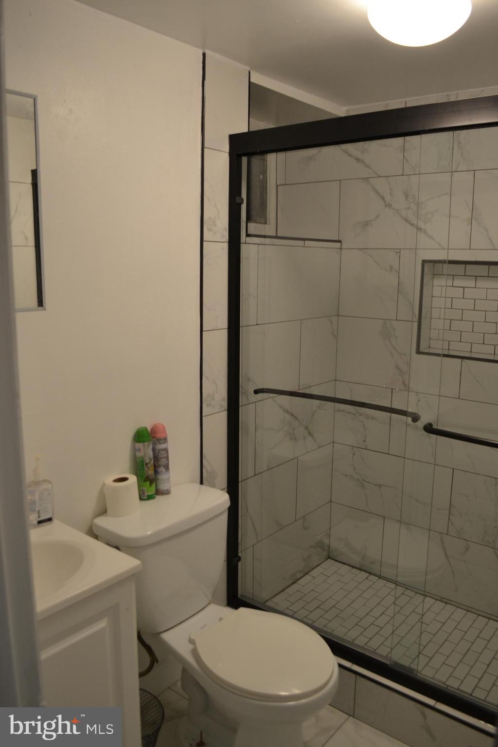 5153 Frederick Avenue Baltimore, MD 21229 - Photo 19 of 29 a bathroom with a sink a toilet and shower