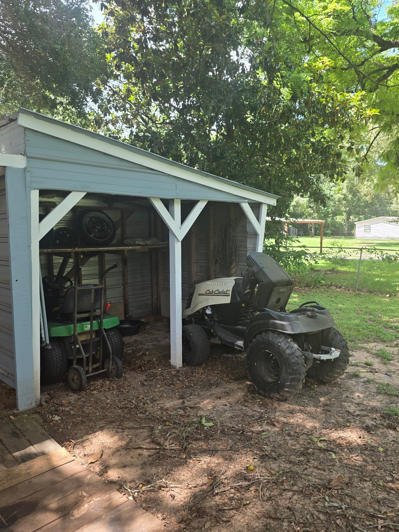 11 Pine Road Coldspring, TX 77331 - Photo 21 of 32 a view of backyard with barbeque grill and a large tree