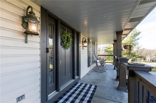 a view of a porch with chairs and backyard