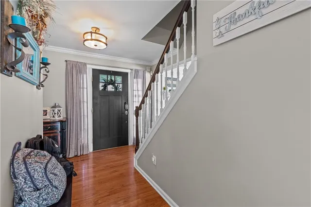 a view of entryway and hall with wooden floor