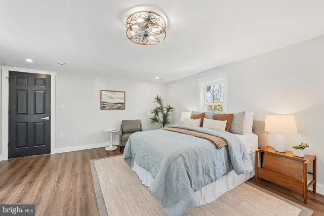 a spacious bedroom with a bed and a table in it