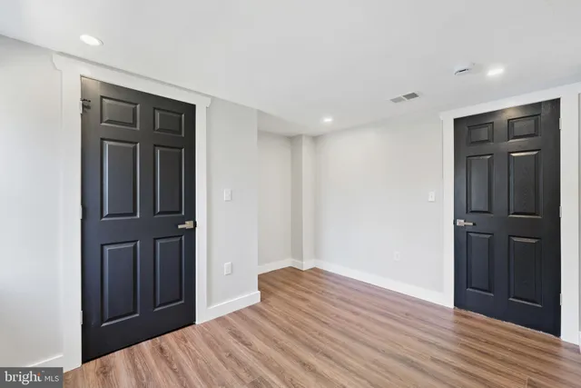 a view of hallway with wooden floor