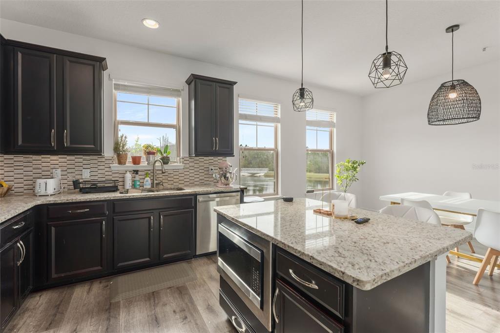 10814 Sunset Ridge Lane Orlando, FL 32832 - Photo 18 of 42 a kitchen with center island and stainless steel appliances