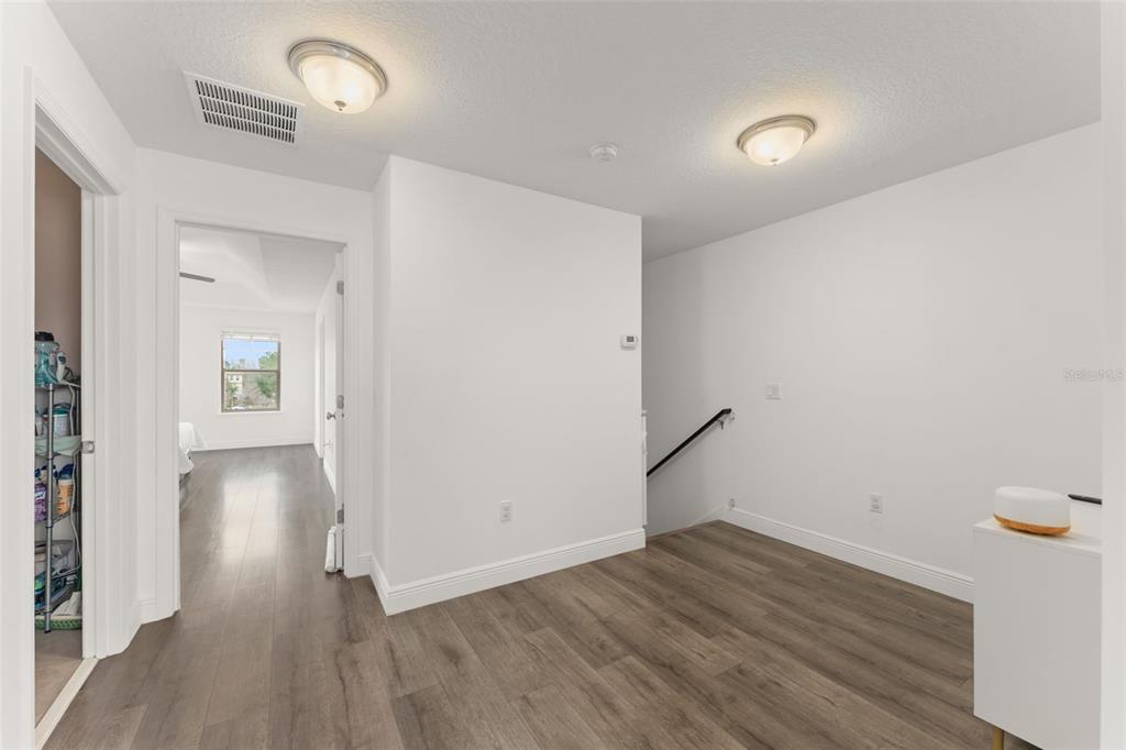 10814 Sunset Ridge Lane Orlando, FL 32832 - Photo 24 of 42 an empty room with wooden floor and windows