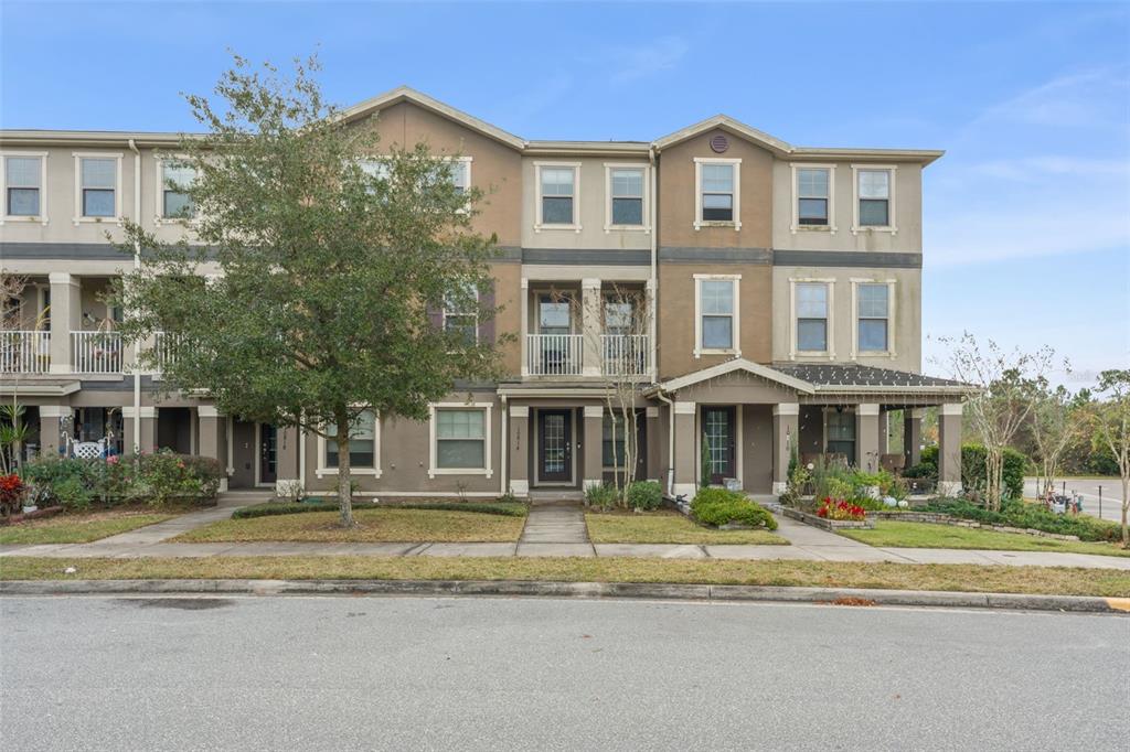 10814 Sunset Ridge Lane Orlando, FL 32832 - Photo 41 of 42 a front view of a residential apartment building with a yard