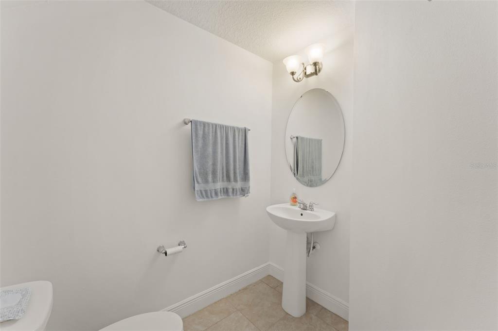 10814 Sunset Ridge Lane Orlando, FL 32832 - Photo 6 of 42 a bathroom with a toilet sink and mirror