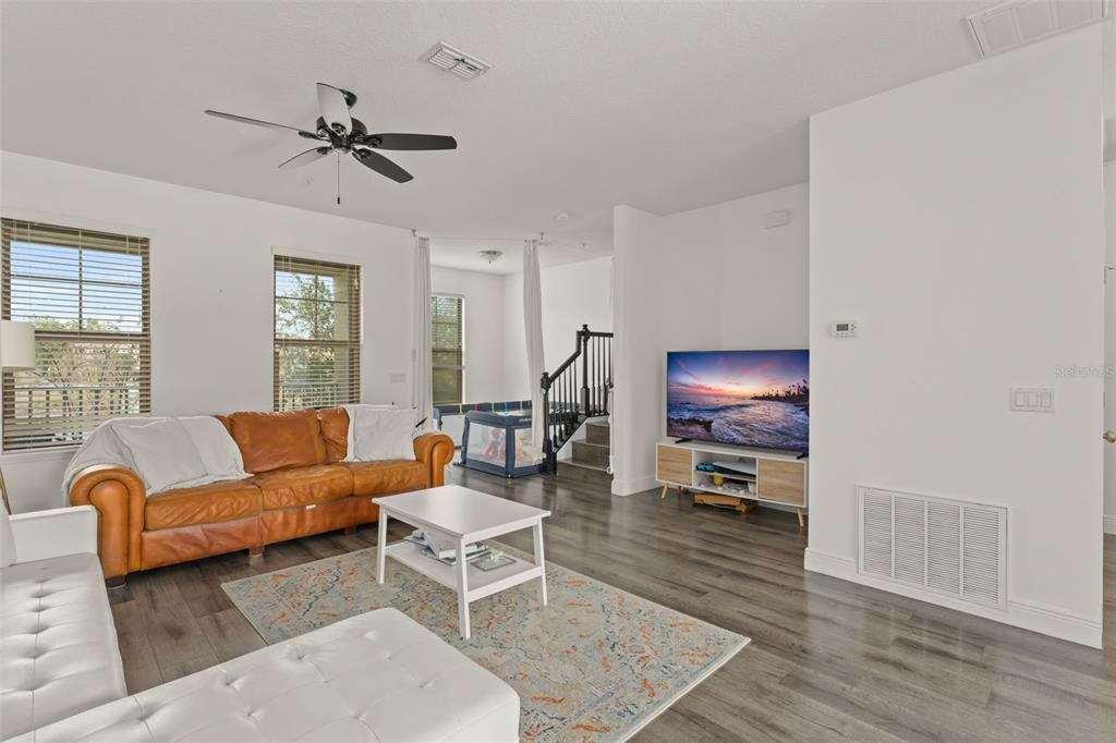 10814 Sunset Ridge Lane Orlando, FL 32832 - Photo 8 of 42 a living room with furniture and a wooden floor