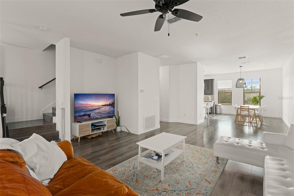 10814 Sunset Ridge Lane Orlando, FL 32832 - Photo 10 of 42 a living room with furniture and a flat screen tv