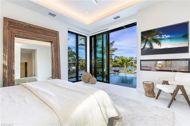 a bedroom with a large bed and a large window