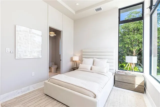 a bedroom with a large bed and a window