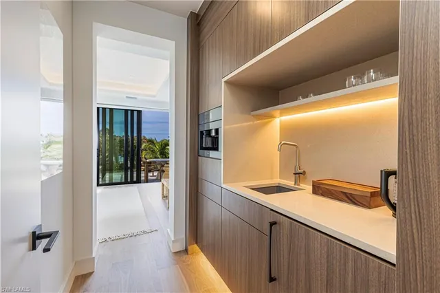 a view of bathroom with a sink and mirror