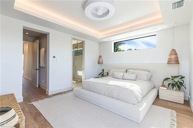 a bedroom with a bed and a potted plant