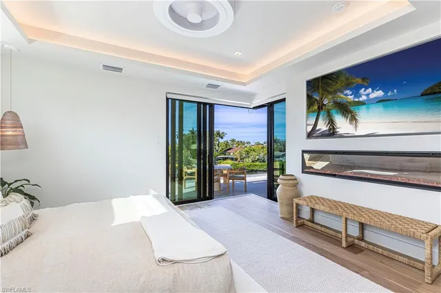 a bedroom with a bed and a potted plant