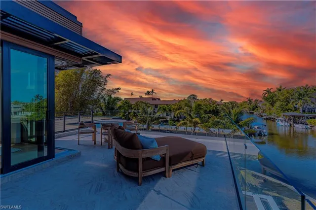 a view of swimming pool with outdoor seating and plants