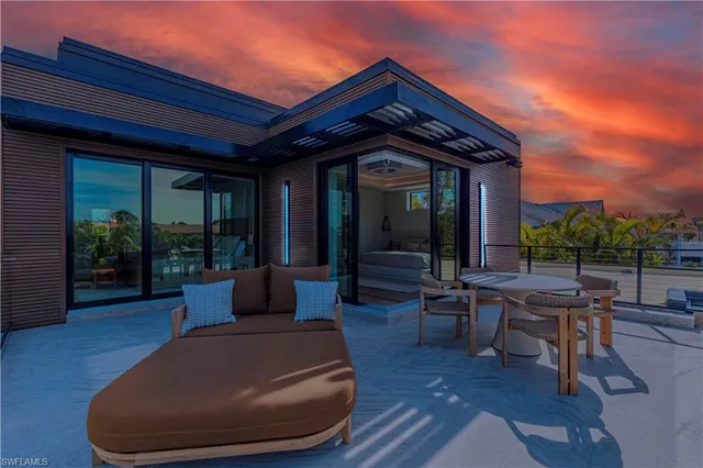 a view of a house with backyard sitting area and garden