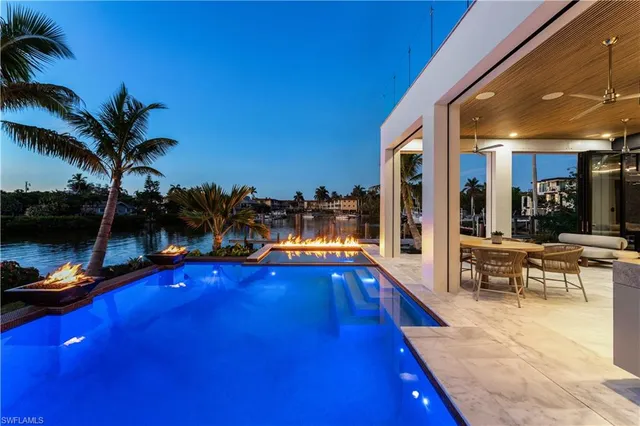 a swimming pool with outdoor seating and yard