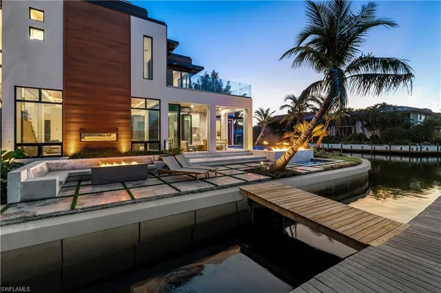 a view of a house with pool and sitting area