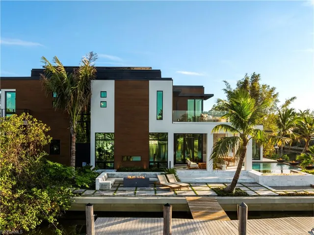 a front view of house with a garden and swimming pool