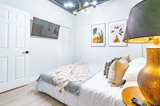 a bedroom with a bed and a flat screen tv