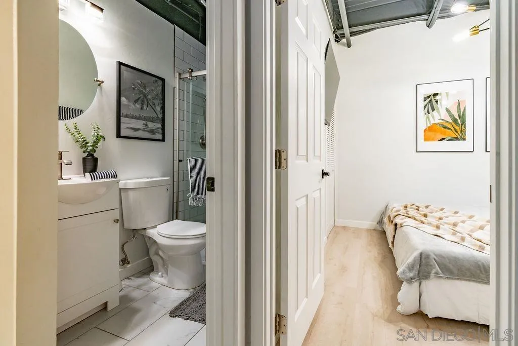 1298 Prospect Street, Unit 2F La Jolla, CA 92037 - Photo 21 of 54 a bathroom with a toilet and a shower curtain