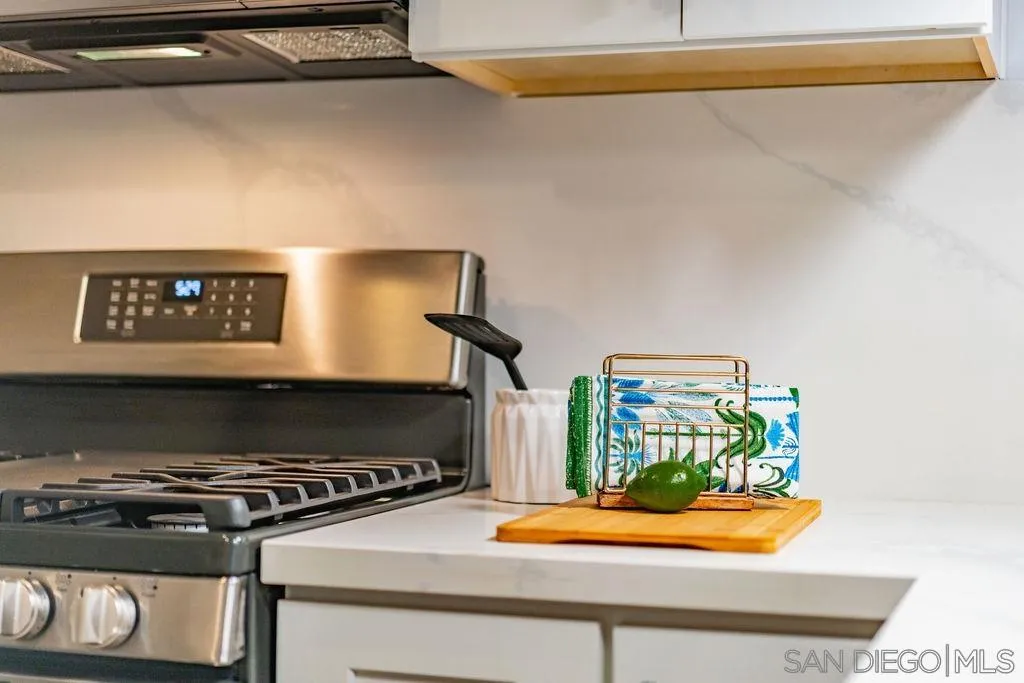1298 Prospect Street, Unit 2F La Jolla, CA 92037 - Photo 40 of 54 a kitchen with a stove and a microwave
