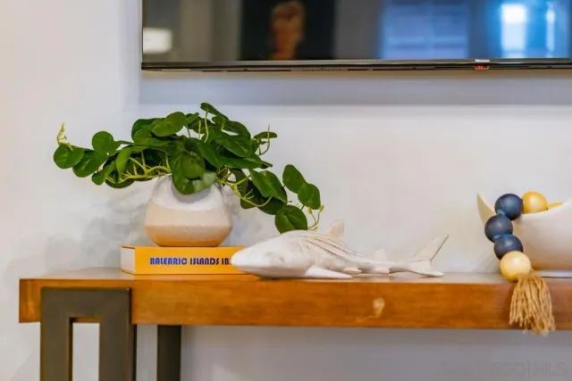 a kitchen with stainless steel appliances granite countertop a dining table chairs and white cabinets
