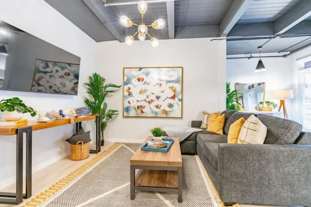 a living room with furniture and a chandelier