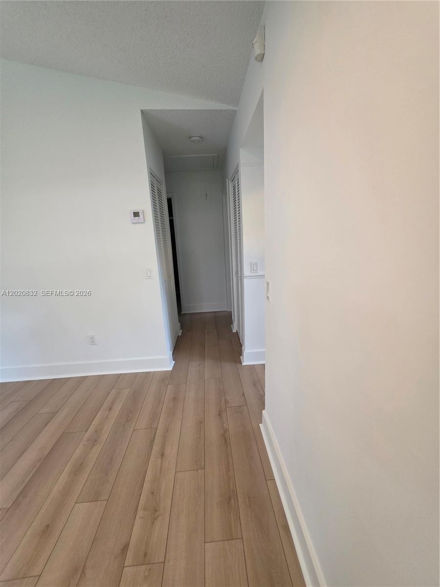 15240 Southwest 45th Terrace, Unit 54F Miami, FL 33185 - Photo 27 of 48 a view of a hallway with wooden floor