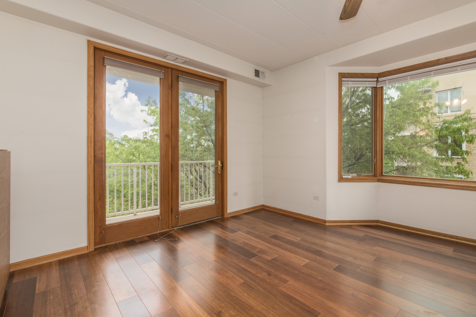 1705 Pavilion Way, Unit 401 Park Ridge, IL 60068 - Photo 14 of 25 a view of an empty room with wooden floor and a window