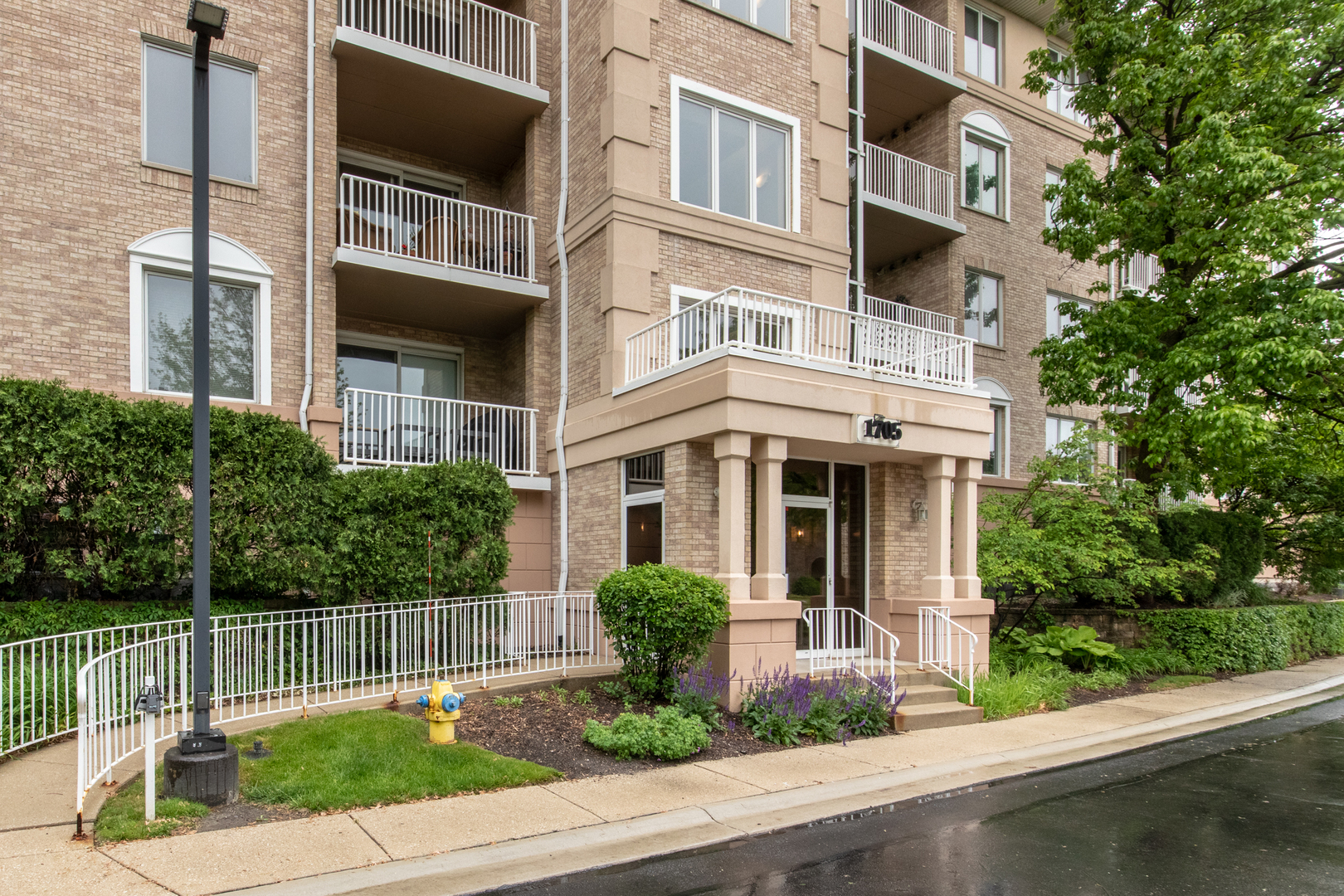 1705 Pavilion Way, Unit 401 Park Ridge, IL 60068 - Photo 2 of 2 a front view of a building with garden