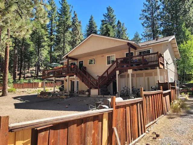a view of a house with wooden fence